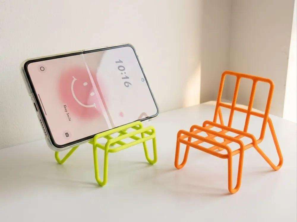 A phone stand in the form of a chair.