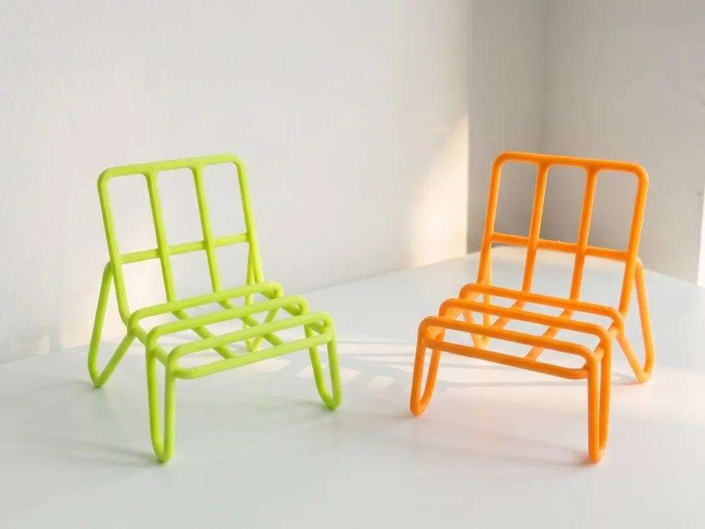 A phone stand in the form of a chair.