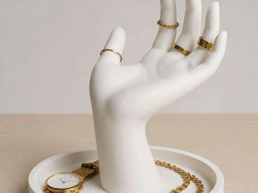 A ring holder in the shape of a hand.