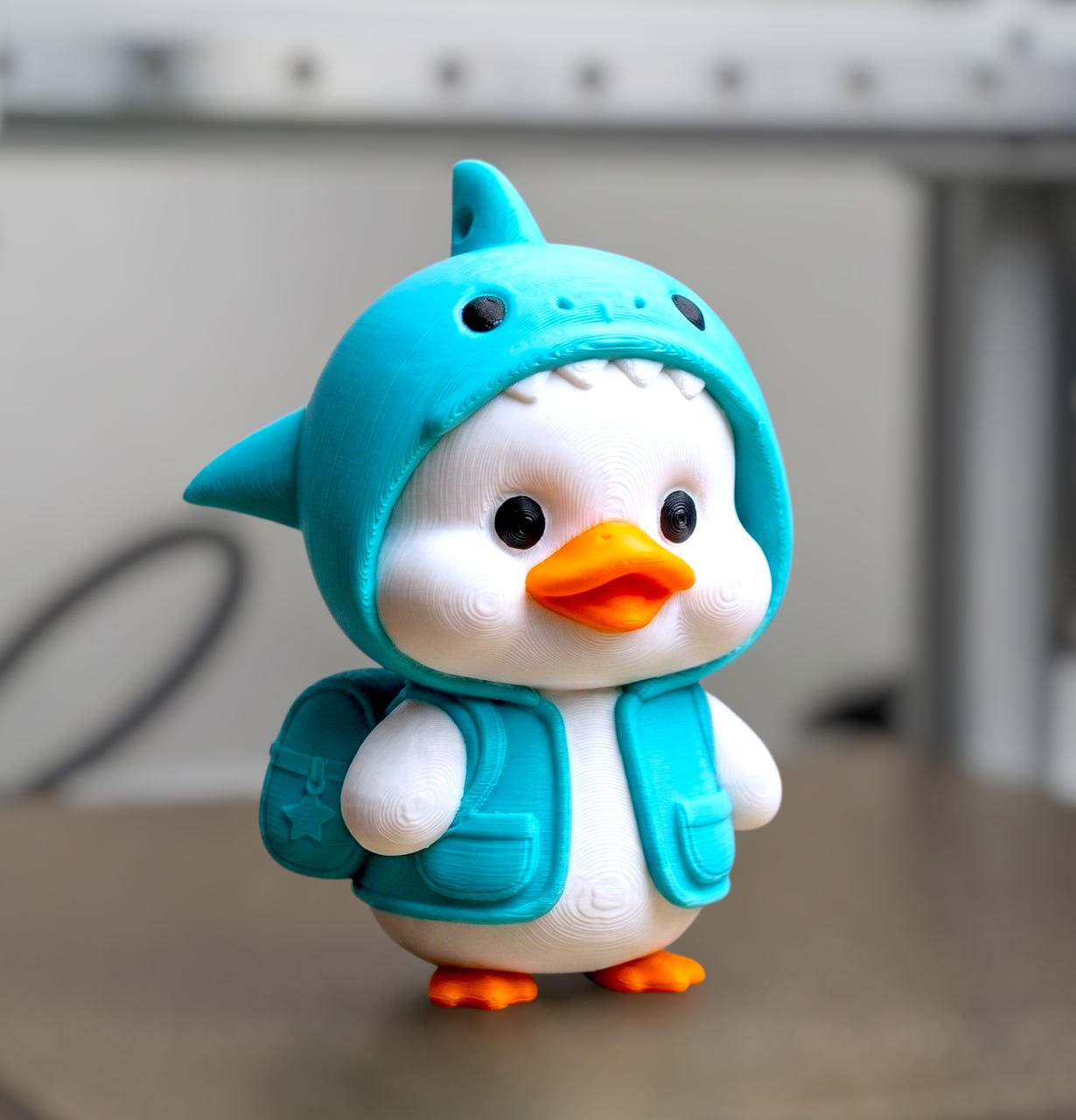 A cute duck in a shark costume.