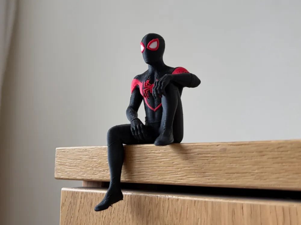 A figurine of Miles Morales, sitting on the shelf.
