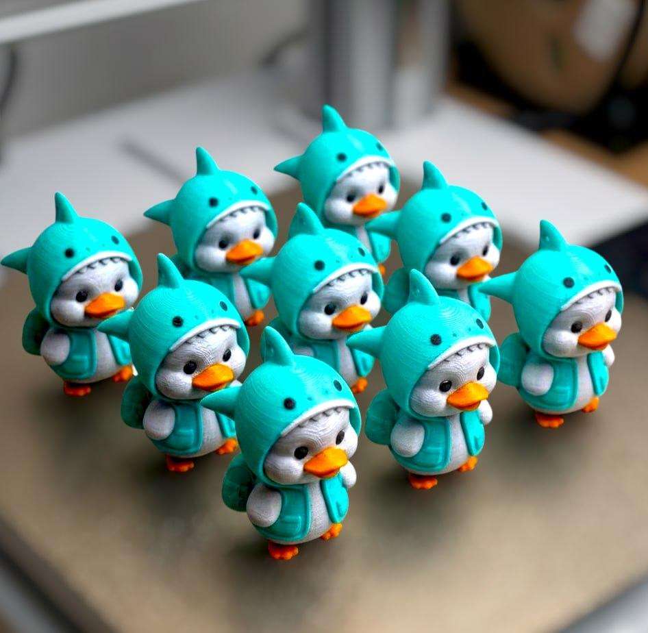 A cute duck in a shark costume.