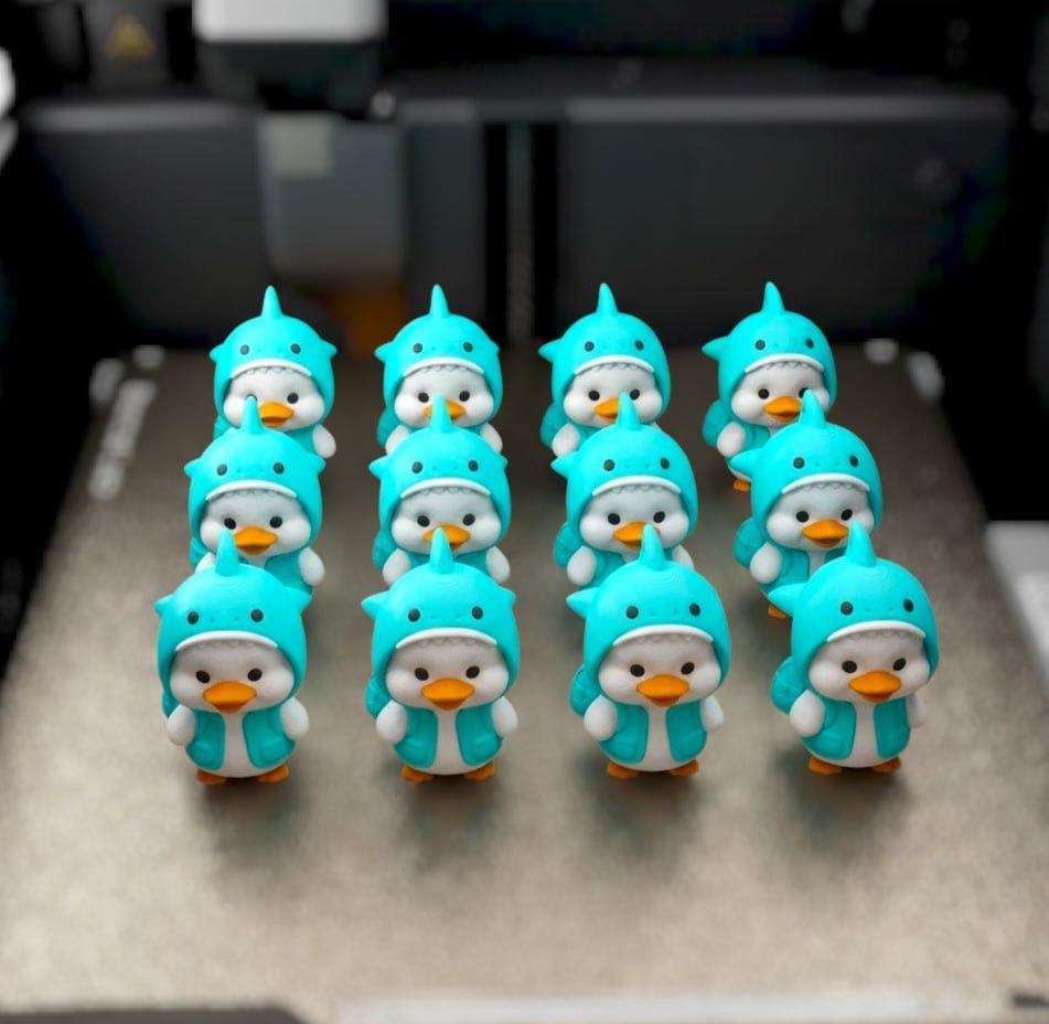 A cute duck in a shark costume.