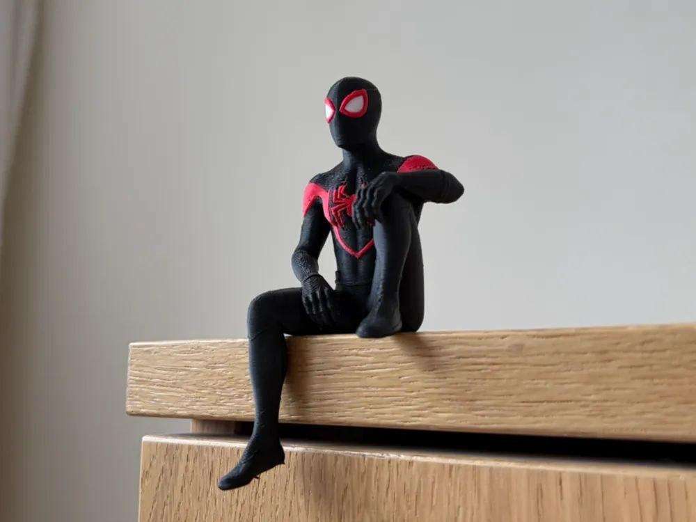 A figurine of Miles Morales, sitting on the shelf.